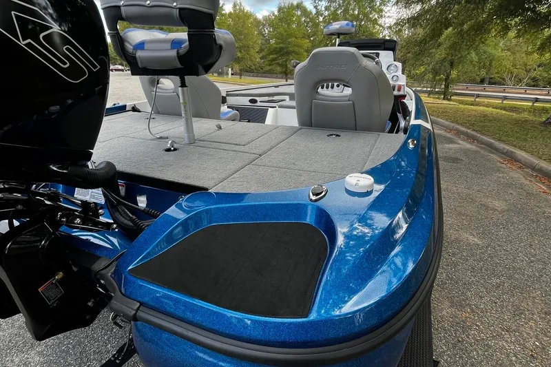 Slide: The Image of 2025 Nitro Z18 Pro boat with blue exterior and gray seating, parked outdoors. - 5