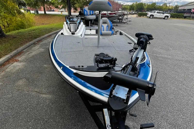 Slide: The Image of 2025 Nitro Z18 Pro fishing boat with trolling motor, parked outdoors. - 7