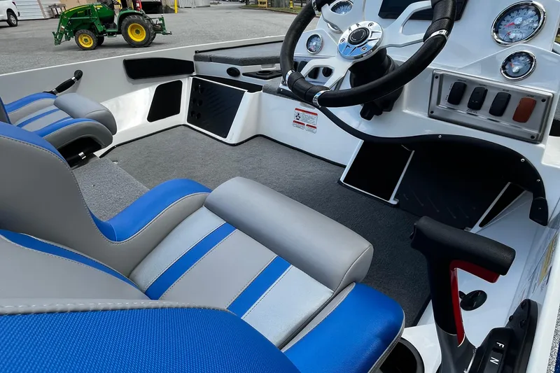 Slide: The Image of 2025 Nitro Z18 Pro boat interior with blue and gray seats, steering wheel, and dashboard controls. - 8