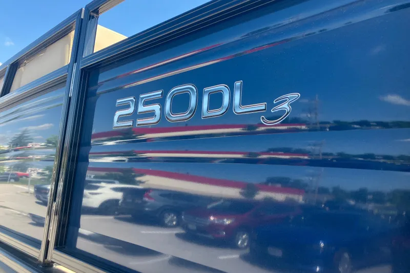 Slide: The Image of 2025 Regency 250 DL3 boat exterior with reflective blue finish. - 2