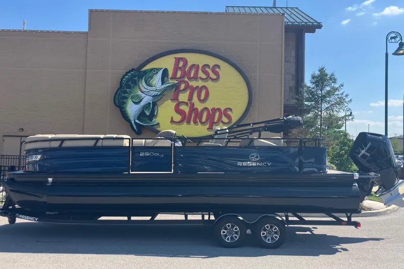 The Image of 2025 Regency 250 DL3 pontoon boat at Bass Pro Shops parking lot. - 0