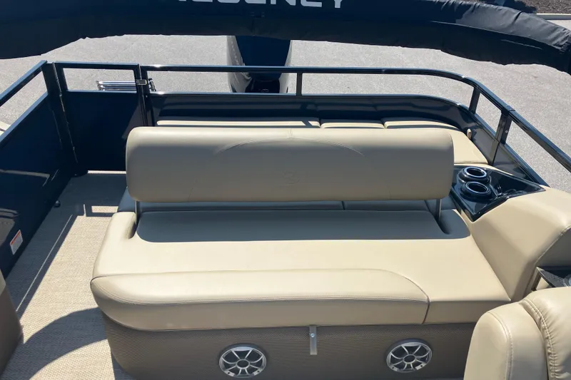 Slide: The Image of 2025 Regency 250 DL3 boat interior with beige seating and cup holders. - 9