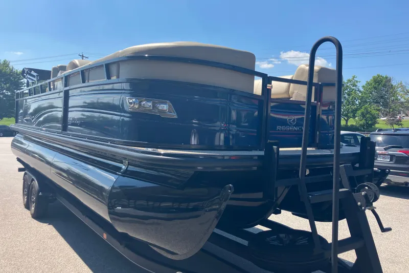 Slide: The Image of 2025 Regency 250 DL3 pontoon boat on trailer, sunny day, rear view. - 3