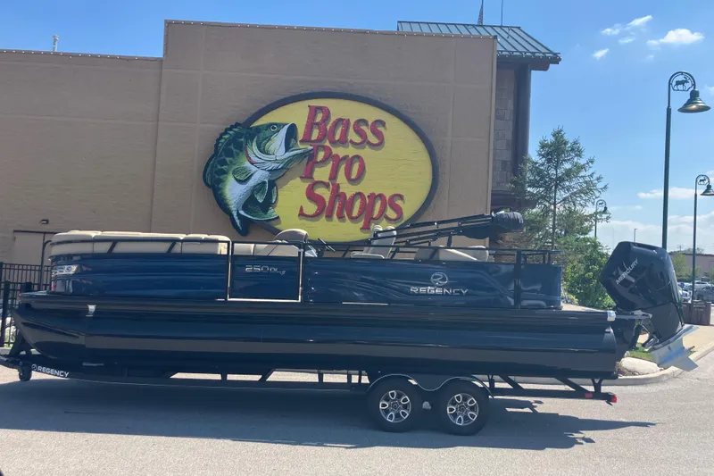 The Image of 2025 Regency 250 DL3 pontoon boat at Bass Pro Shops parking lot. - 0