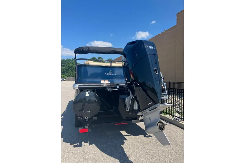 Slide: The Image of 2025 Regency 250 DL3 boat with powerful outboard motor, parked outdoors under clear blue sky. - 5