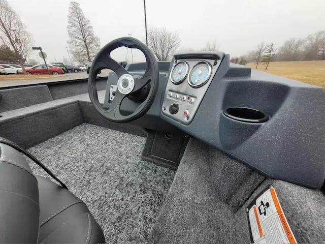 Slide: The Image of 2025 Tracker Pro Guide V-16 SC boat interior with steering wheel and dashboard controls. - 3