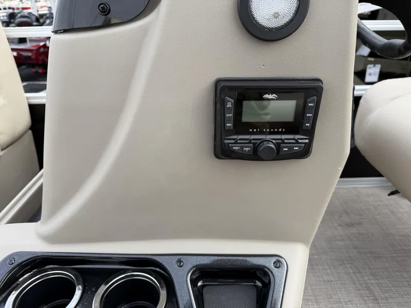 Slide: The Image of Control panel and cup holders on a 2025 Sun Tracker Party Barge 16 DLX. - 11