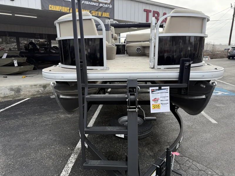 Slide: The Image of 2025 Sun Tracker Party Barge 16 DLX pontoon boat on display at dealership. - 2