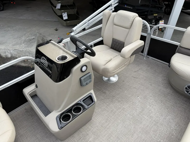 Slide: The Image of 2025 Sun Tracker Party Barge 16 DLX interior with captain's chair and console. - 8