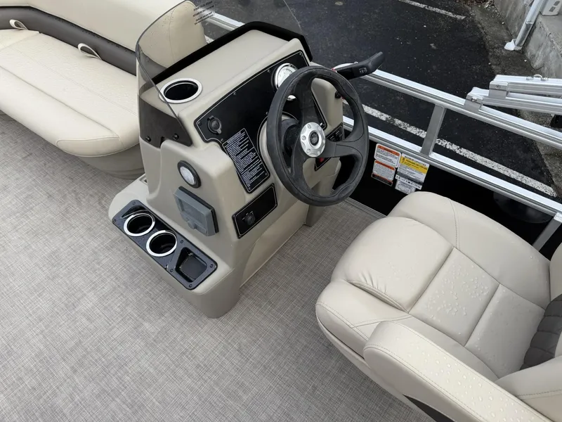 Slide: The Image of 2025 Sun Tracker Party Barge 16 DLX interior with steering console and seating. - 9