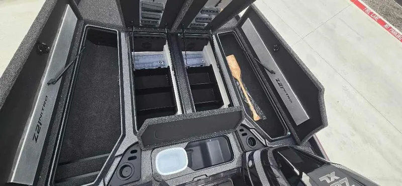 Slide: The Image of 2025 Nitro Z21 XL boat storage compartments, open and organized, showcasing ample space. - 14