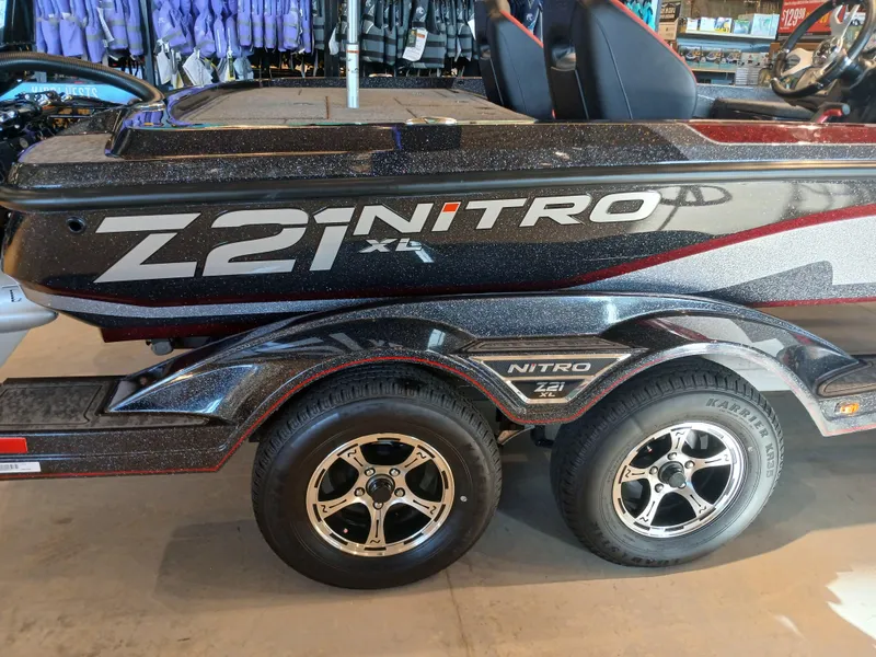 Slide: The Image of 2025 Nitro Z21 XL boat on trailer, featuring sleek design and dual wheels. - 16