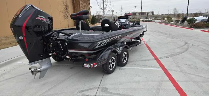 Slide: The Image of 2025 Nitro Z21 XL boat on trailer, parked in urban area. - 2