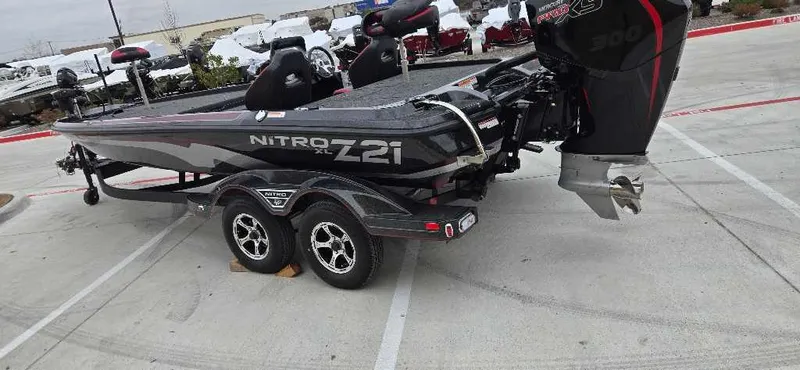 Slide: The Image of 2025 Nitro Z21 XL boat on trailer, parked in a lot. - 3