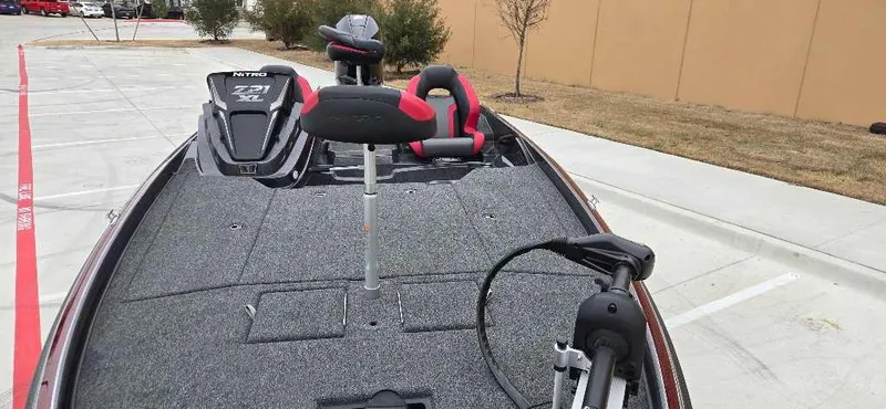 Slide: The Image of 2025 Nitro Z21 XL boat with modern seating and equipment in a parking area. - 5