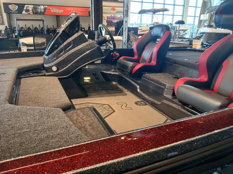 Slide: The Image of 2025 Nitro Z21 XL boat interior with red and black seats, sleek dashboard, and spacious layout. - 8