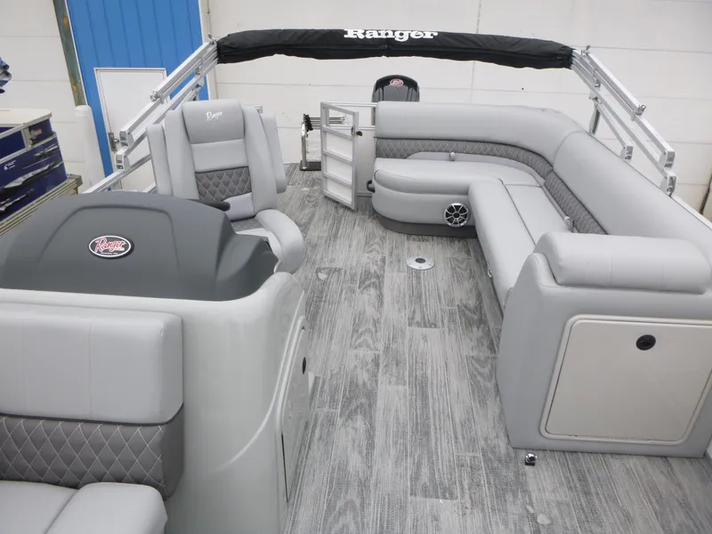 Slide: The Image of 2025 Ranger Reata 220C boat interior with gray seating and storage compartment. - 11