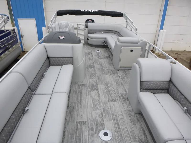 Slide: The Image of 2025 Ranger Reata 220C boat storage compartments with cushioned seating and quilted design. - 14