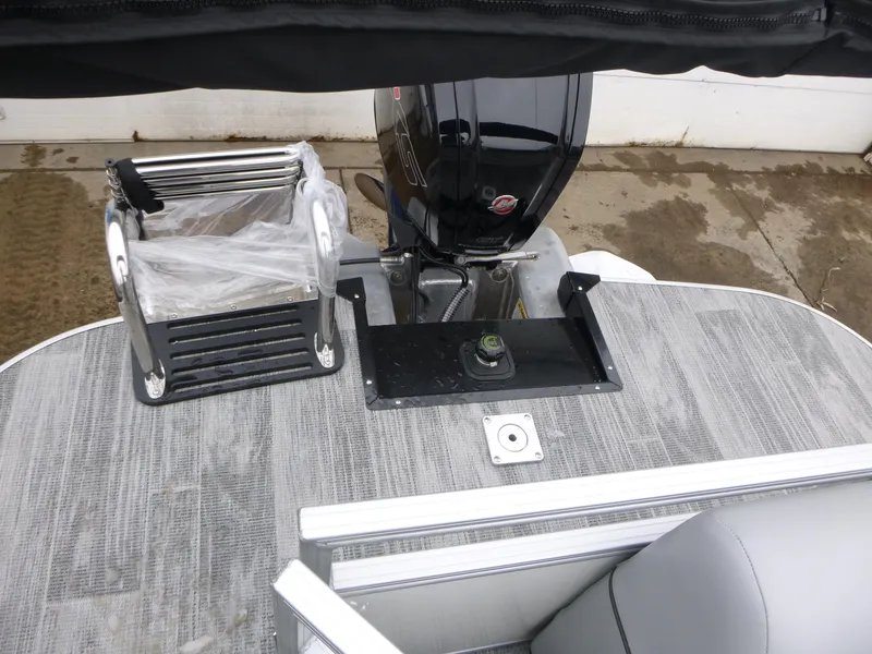 Slide: The Image of 2025 Ranger Reata 220C pontoon boat with luxurious gray seating and modern helm. - 6