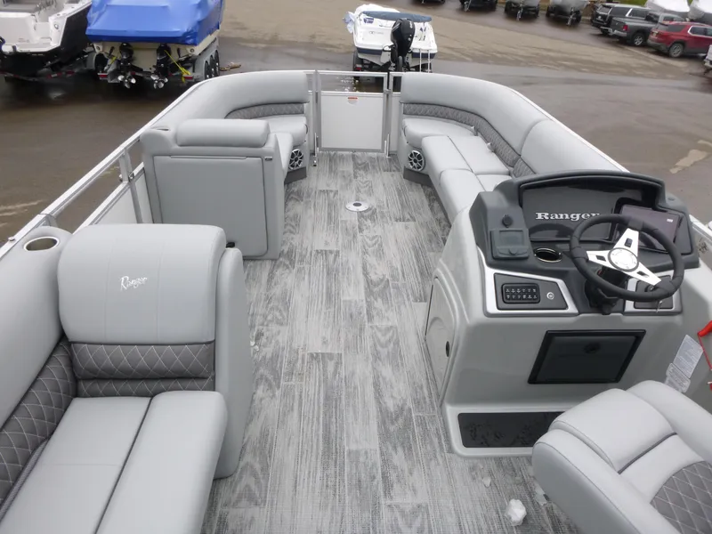 Slide: The Image of 2025 Ranger Reata 220C boat console with steering wheel and controls, featuring modern design. - 7