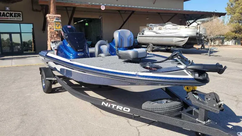 Slide: The Image of 2025 Nitro Z17 boat on trailer, parked outdoors, featuring sleek design and modern seating. - 3