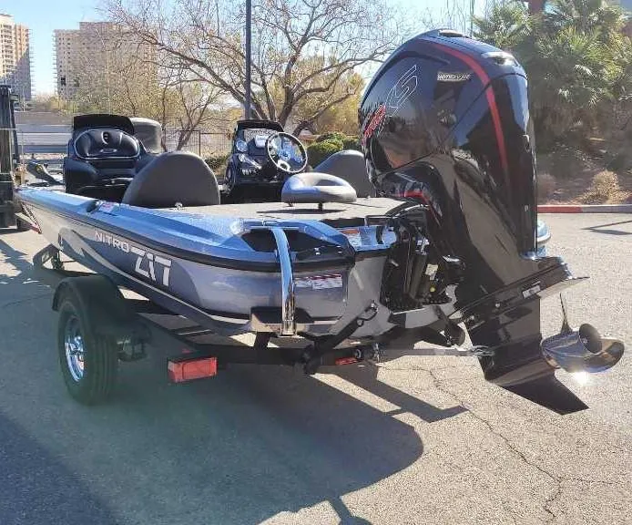 Slide: The Image of 2025 Nitro Z17 boat with powerful outboard motor, parked on a trailer in a sunny setting. - 4