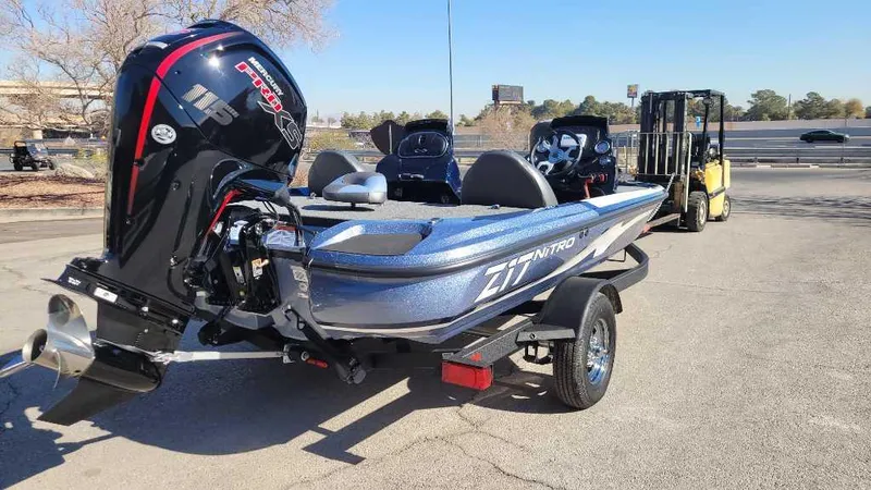 Slide: The Image of 2025 Nitro Z17 boat on trailer, featuring powerful outboard motor, parked outdoors. - 7