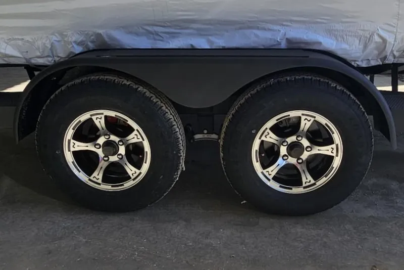 Slide: The Image of 2025 Nitro Z20 XL Pro trailer wheels, dual axle, black and silver rims. - 13