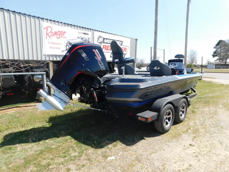 Slide: The Image of 2025 Nitro Z20 XL Pro boat on trailer, parked outdoors near dealership. - 2