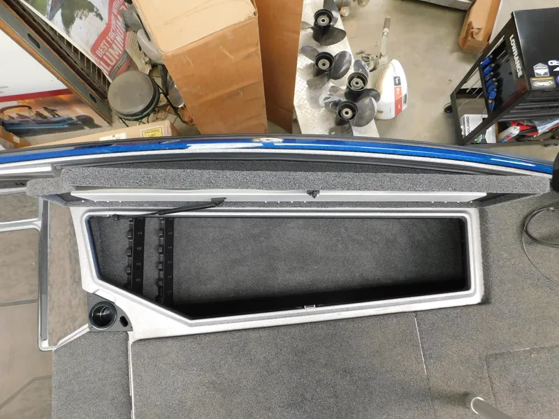 Slide: The Image of 2025 Nitro Z20 XL Pro boat storage compartment with gray interior and blue trim. - 8