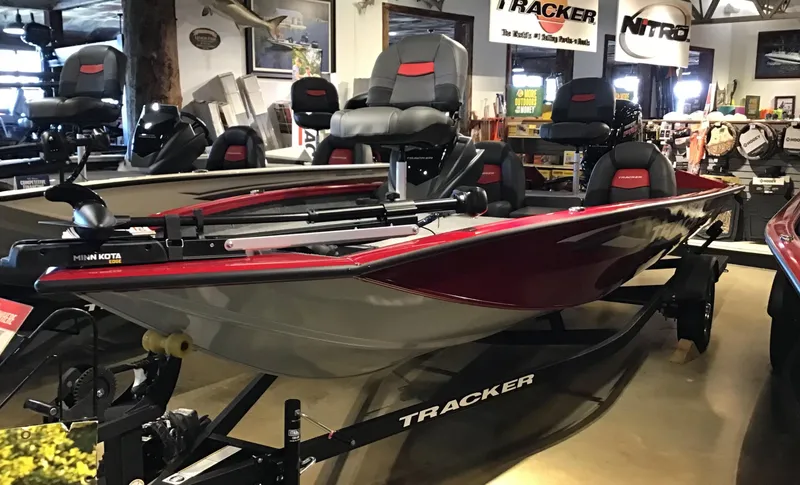 The Image of 2025 Tracker Pro Team 190 boat displayed in showroom, featuring sleek design and comfortable seating. - 0