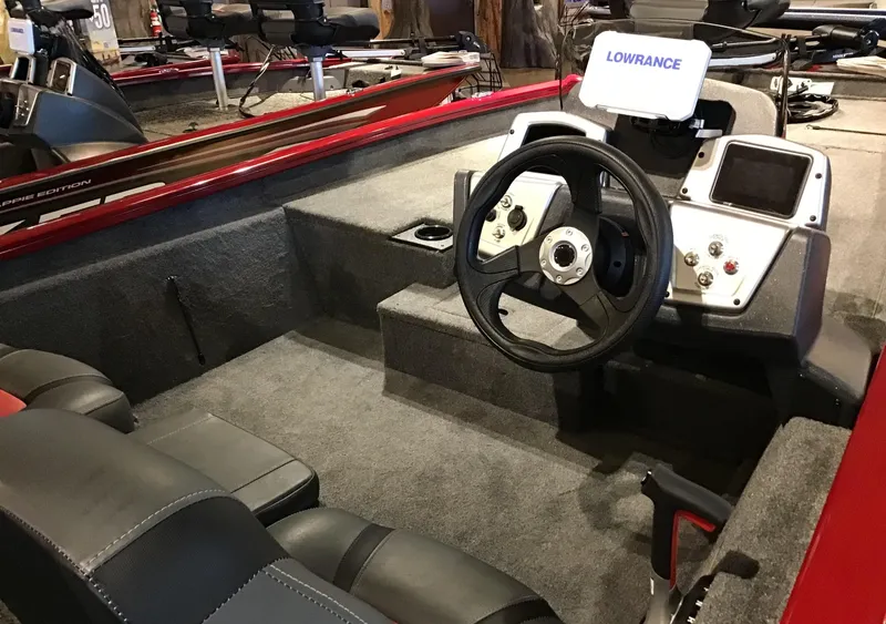 Slide: The Image of 2025 Tracker Pro Team 190 boat interior with steering wheel and Lowrance electronics. - 2