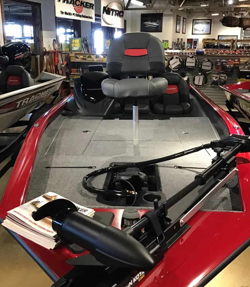 Slide: The Image of 2025 Tracker Pro Team 190 boat, red interior, showroom display. - 3
