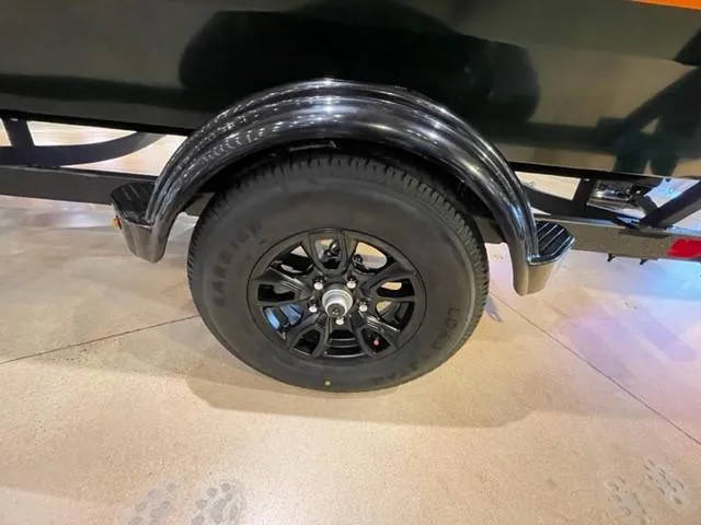 Slide: The Image of 2025 Tracker Bass Tracker Classic Limited trailer wheel and fender on display. - 3