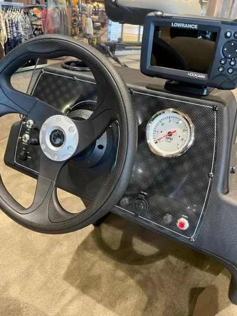Slide: The Image of 2025 Tracker Bass Tracker Classic Limited dashboard with steering wheel and Lowrance fishfinder. - 46