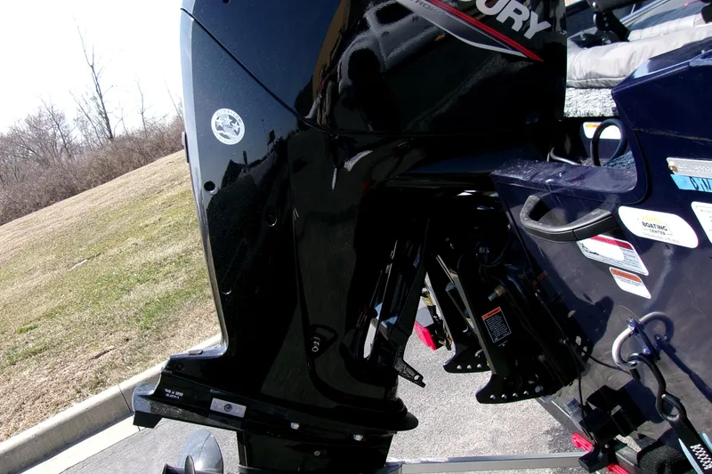 Slide: The Image of 2025 Tracker Pro Guide V-16 SC boat with Mercury outboard motor, parked on pavement. - 4