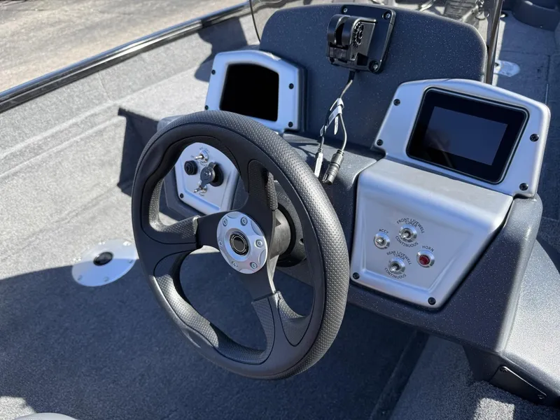 Slide: The Image of Steering console of 2025 Tracker Pro Team 175 Crappie Edition boat with modern controls. - 11