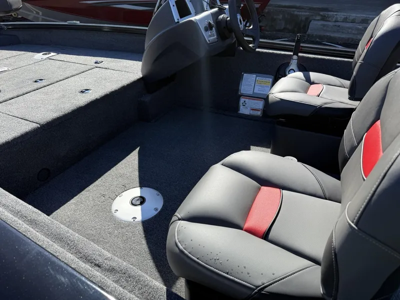 Slide: The Image of 2025 Tracker Pro Team 175 Crappie Edition boat interior with gray and red seating. - 4