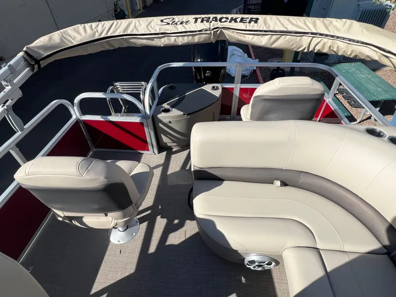 Slide: The Image of 2025 Sun Tracker Bass Buggy 18 DLX interior with beige seating and red accents. - 4