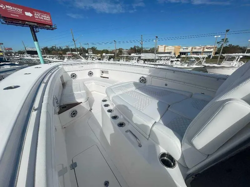Slide: The Image of 2024 Caymas 401 CC boat interior with white seating and cup holders. - 10