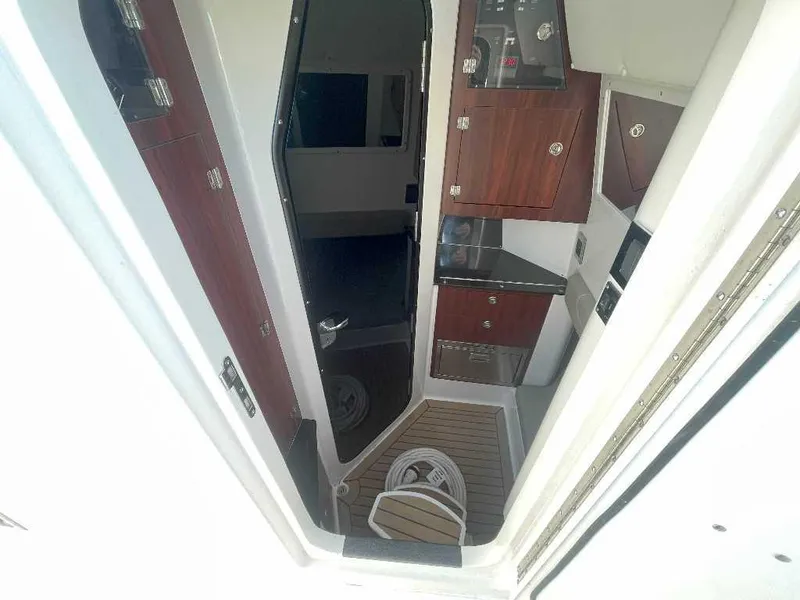 Slide: The Image of Interior view of 2024 Caymas 401 CC boat, featuring wooden cabinetry and modern design. - 14