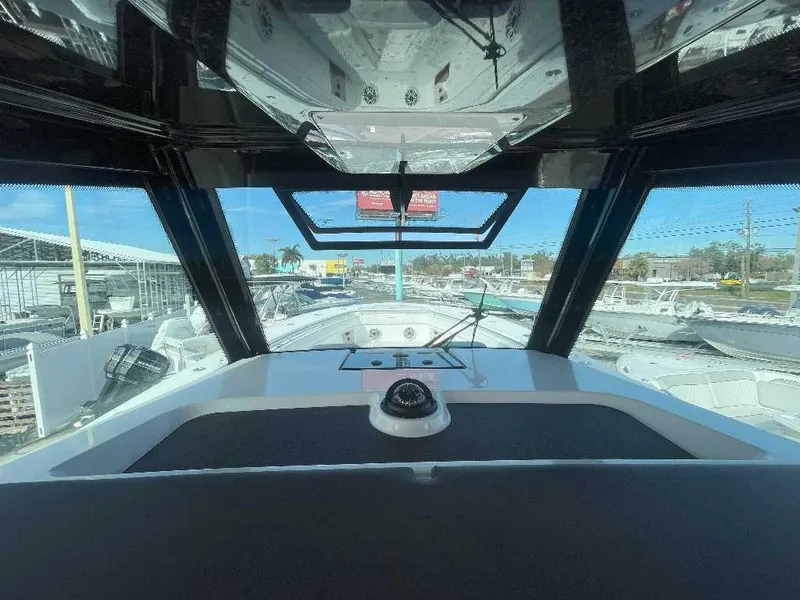 Slide: The Image of 2024 Caymas 401 CC boat interior view with windshield and dashboard. - 3