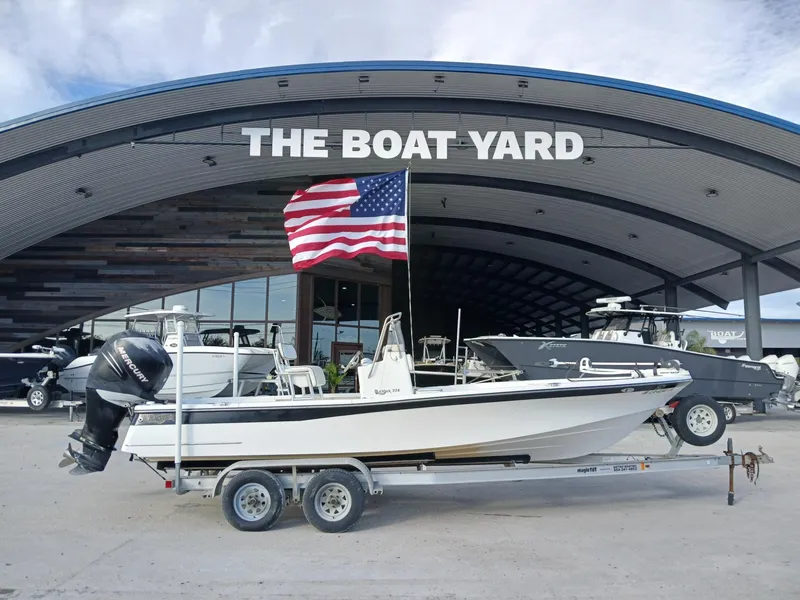 Slide: The Image of 2005 BlackJack 224 boat on trailer at The Boat Yard with American flag. - 1