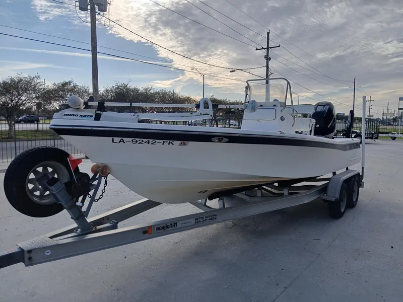 Slide: The Image of 2005 BlackJack 224 boat on trailer, parked outdoors under cloudy sky. - 10