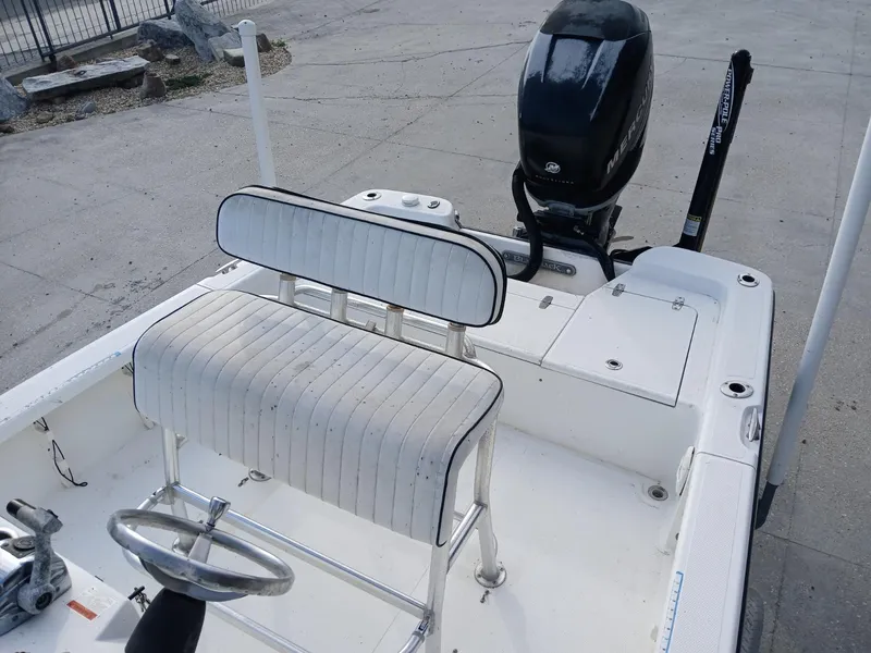 Slide: The Image of 2005 BlackJack 224 boat interior with steering wheel and seating. - 3