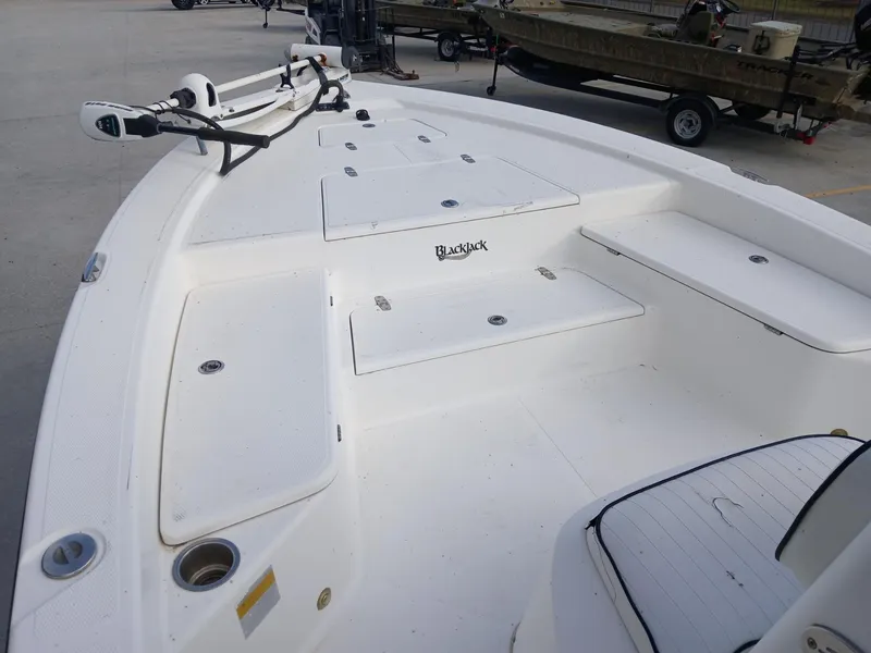 Slide: The Image of 2005 BlackJack 224 boat deck with storage compartments and trolling motor. - 6