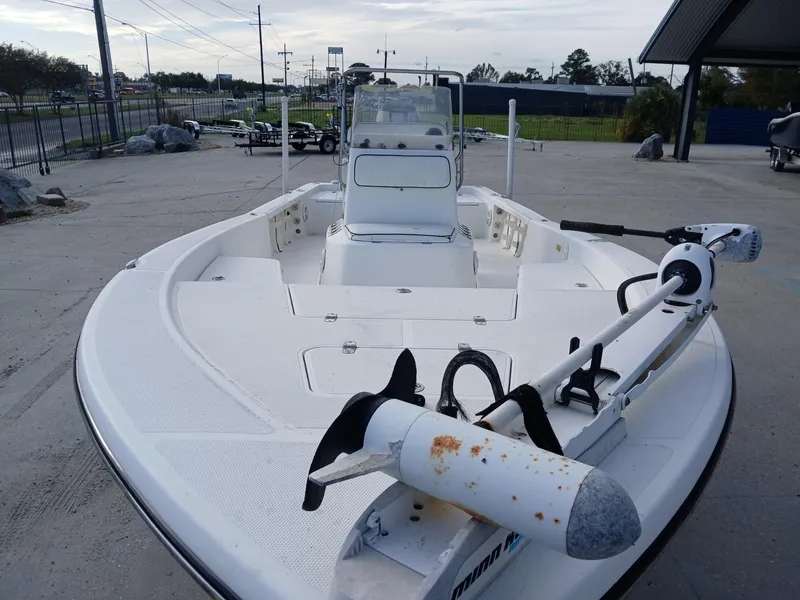Slide: The Image of 2005 BlackJack 224 boat with trolling motor, parked outdoors on concrete surface. - 8