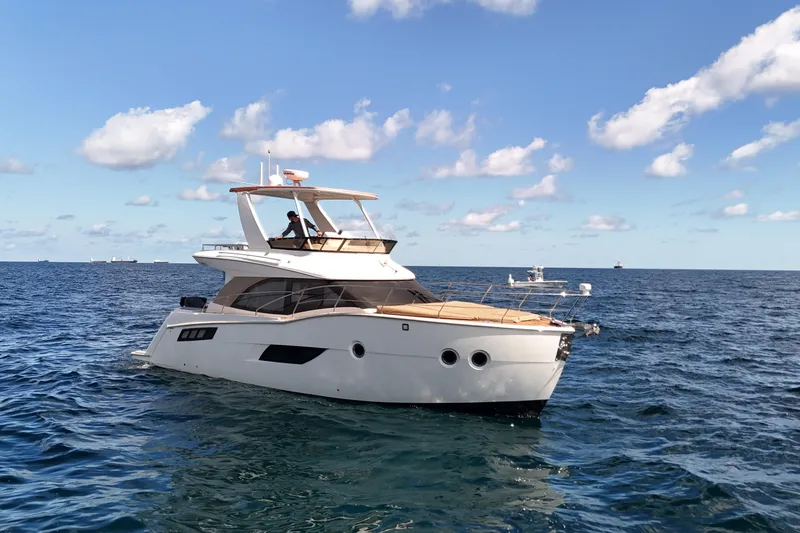 Slide: The Image of 2014 Carver 40 Command Bridge yacht cruising on open sea under blue sky. - 3