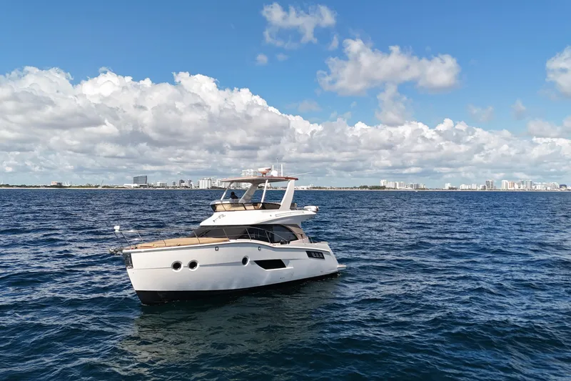 Slide: The Image of 2014 Carver 40 Command Bridge yacht on open sea under blue sky. - 5