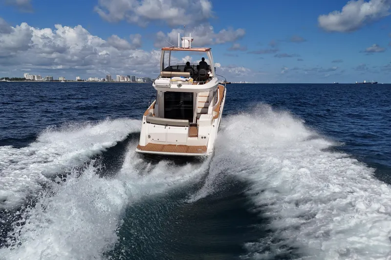 Slide: The Image of 2014 Carver 40 Command Bridge cruising on open water, city skyline in background. - 15